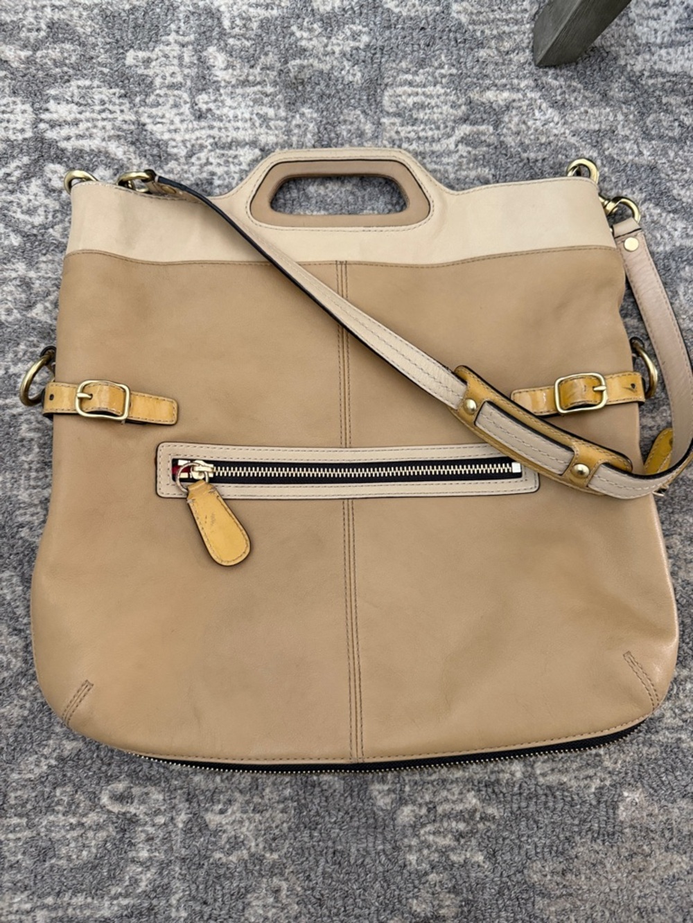Coach Bonnie leather foldover convertible bag in a tan and cream color